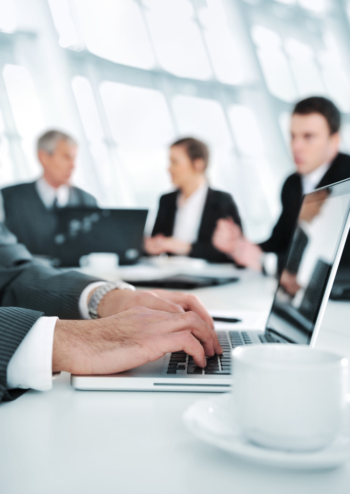 Business people working on laptop during the meeting